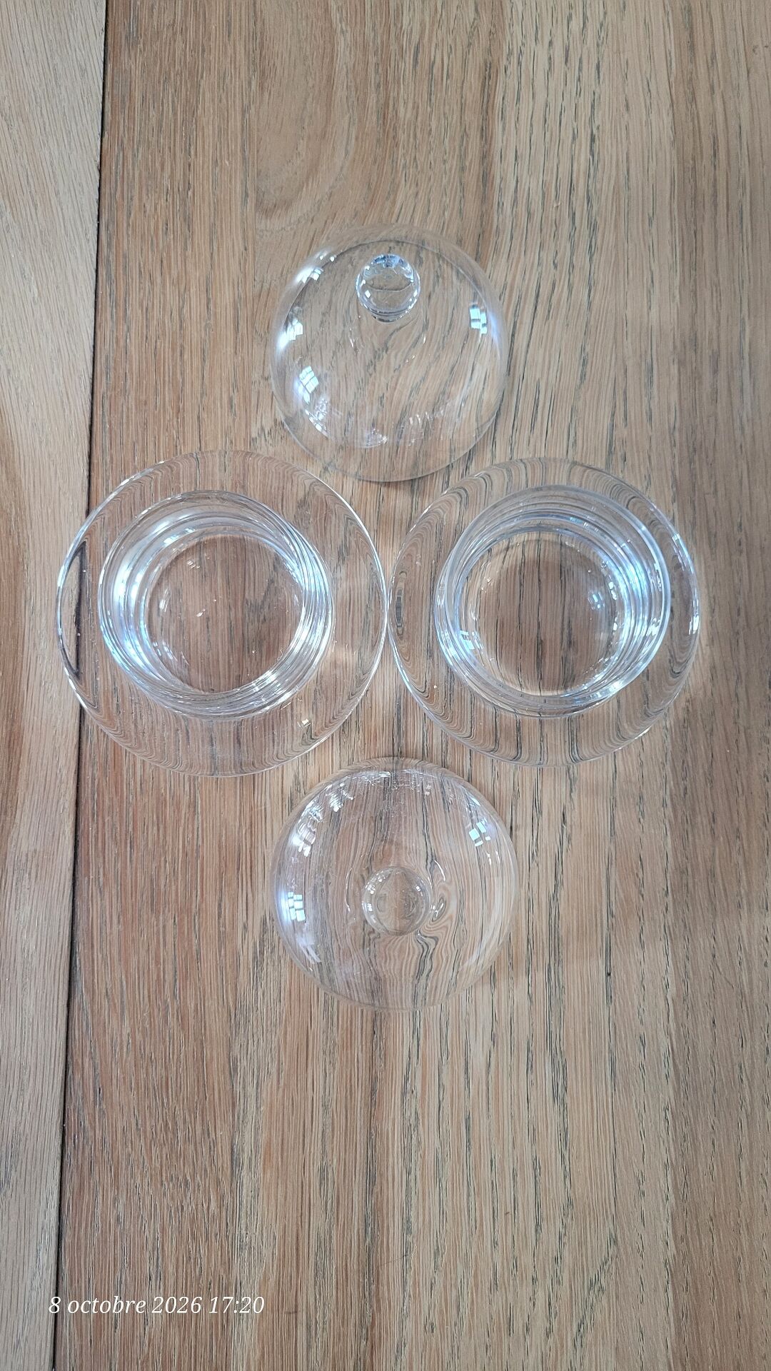 2 transparent glass butter dishes with their matching cloches.