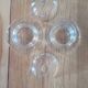 2 transparent glass butter dishes with their matching cloches.