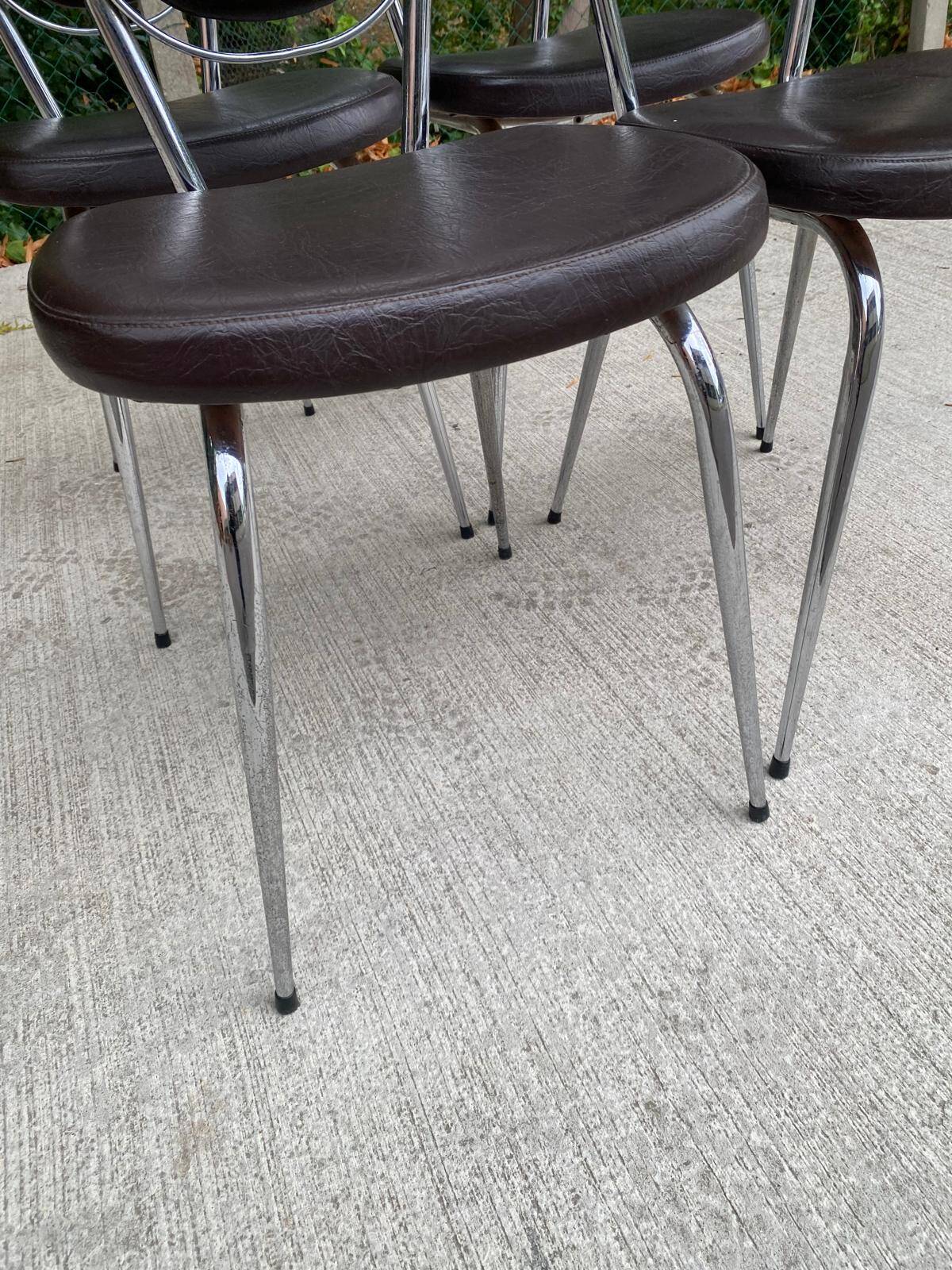 Set of 4 vintage chairs from the 60s/70s in brown faux leather with chrome compass legs.