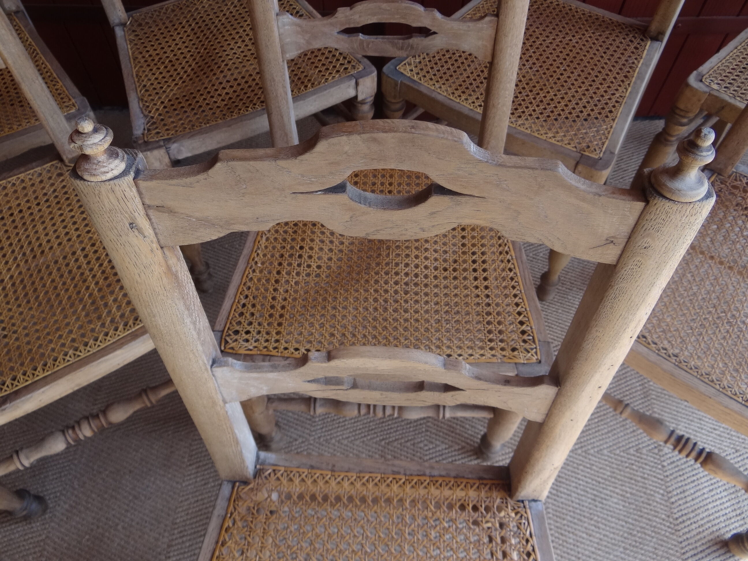 Suite of oak chairs; canated seats