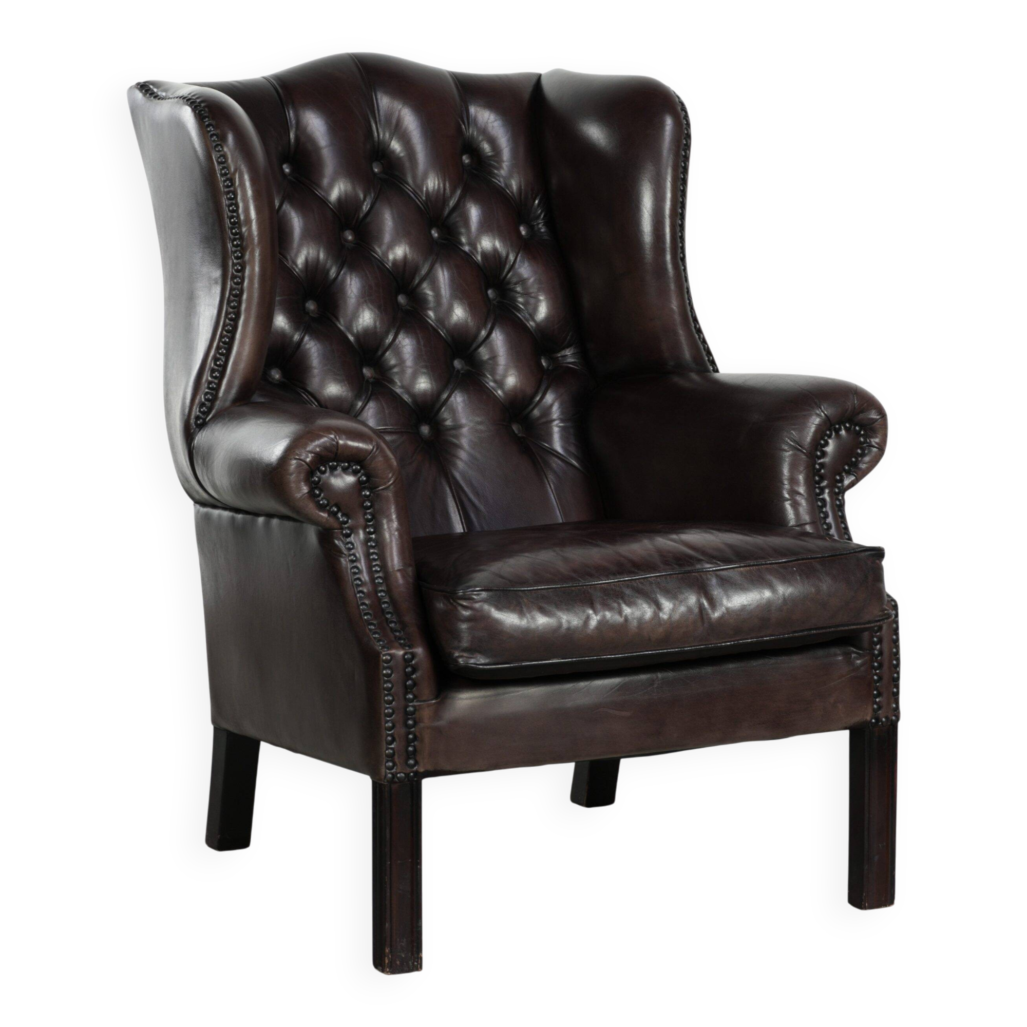 Dark brown cowhide Chesterfield wingback armchair in classic English style