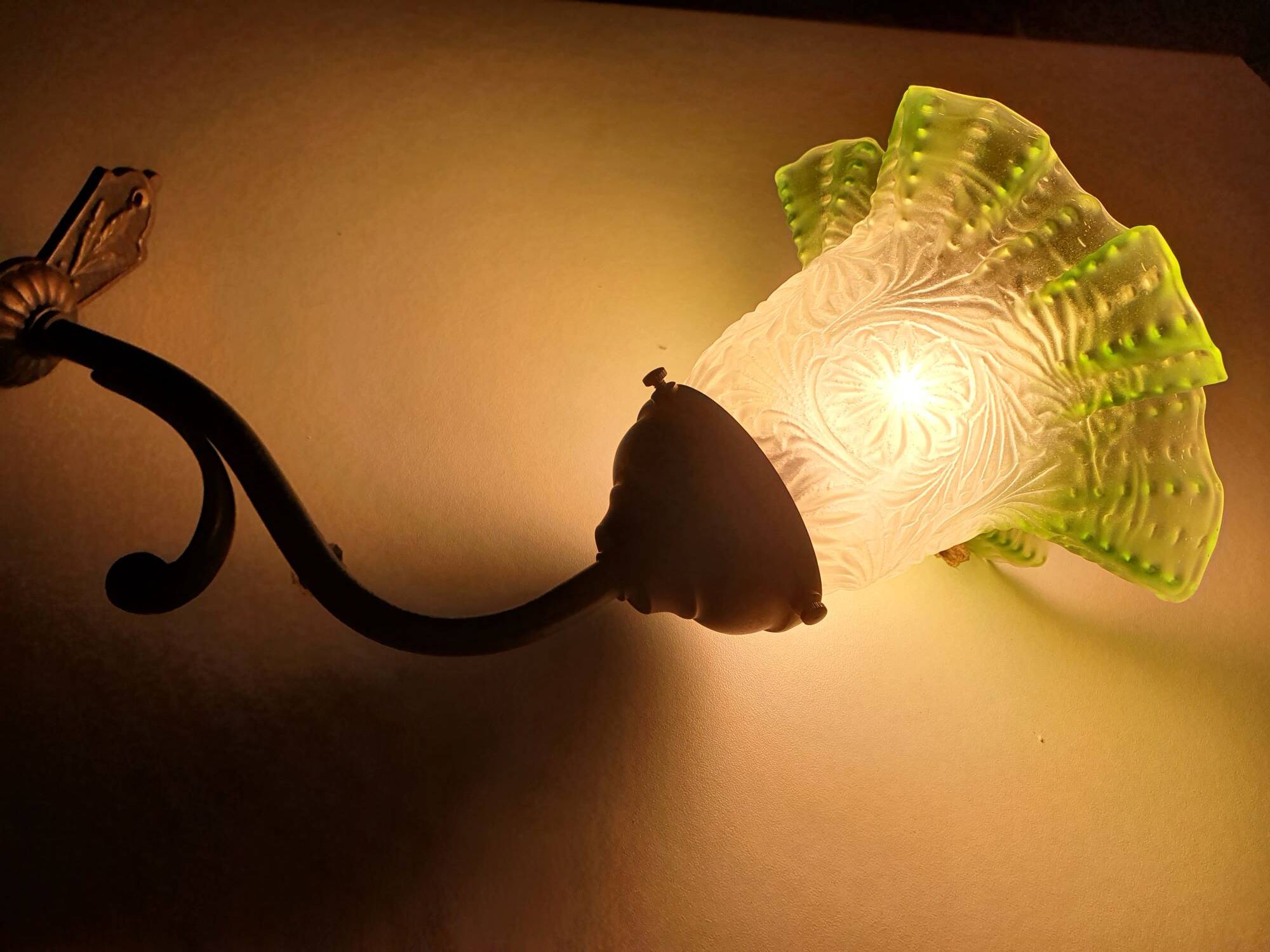 Antique brass wall light with art deco molded glass