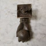 Antique cast iron door knocker in the shape of a 19th century hand
