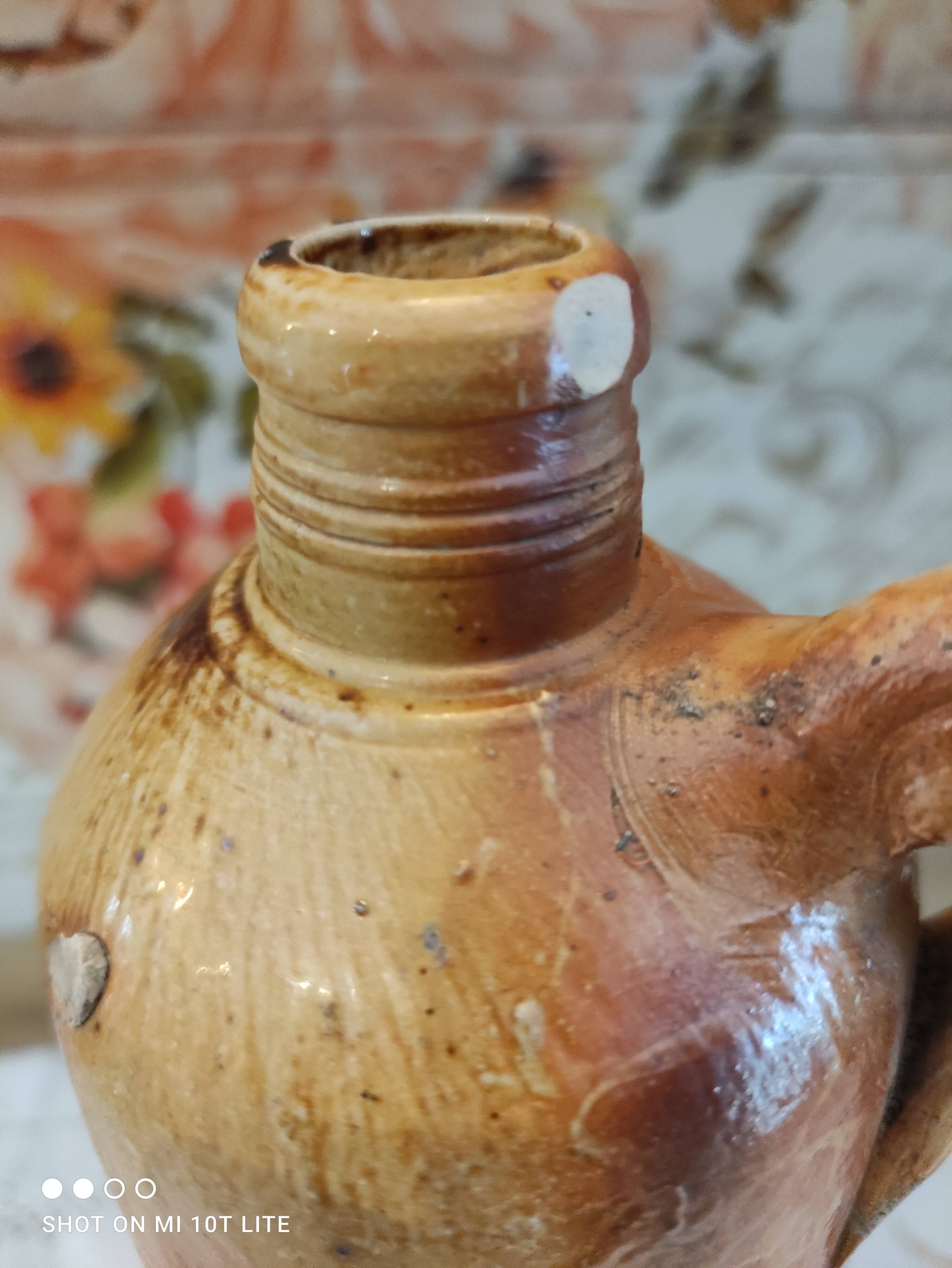Old bottle in terracotta varnished finish