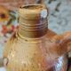 Old bottle in terracotta varnished finish