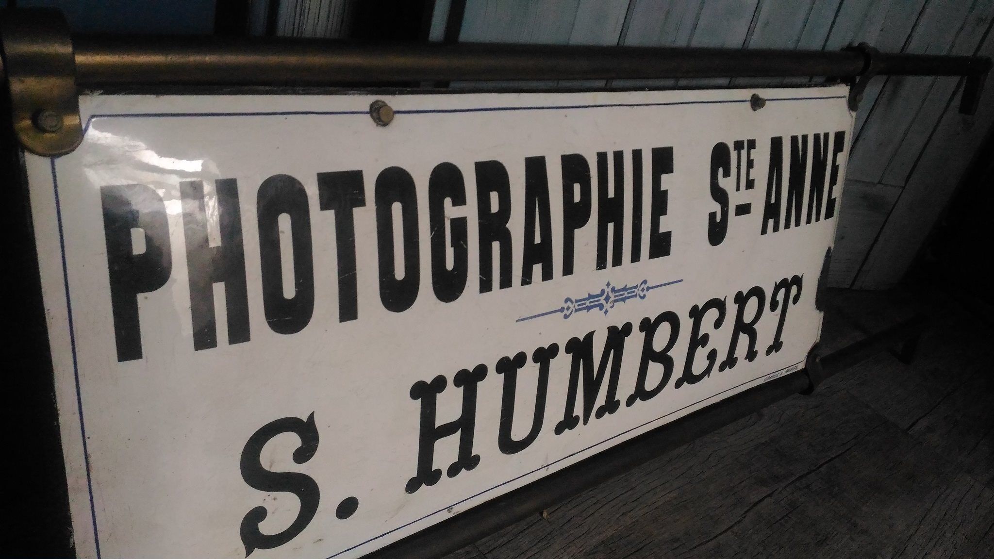 Photographer enamel sign