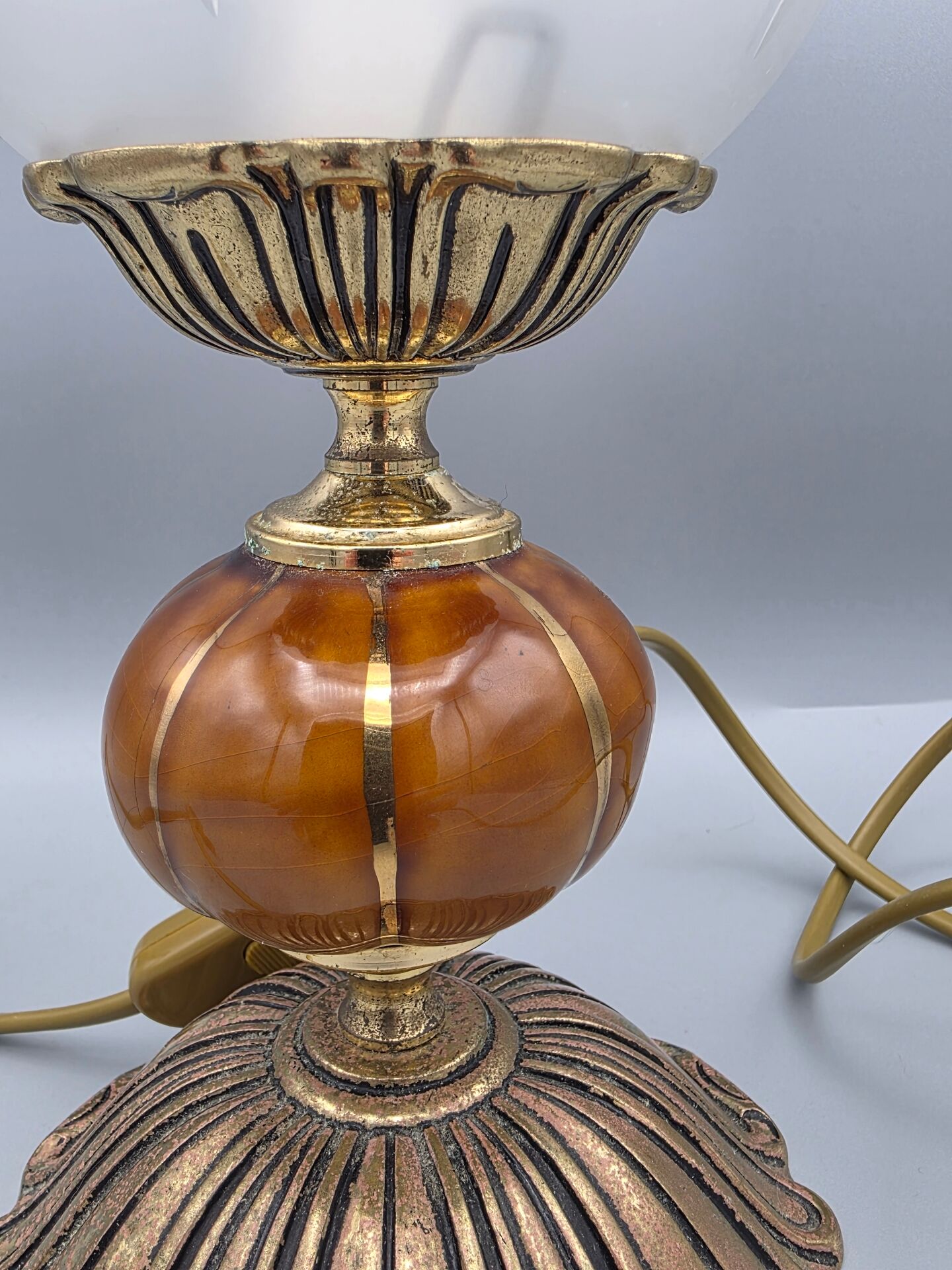 Hollywood Regency bedside lamp in gold metal with a glass globe.
