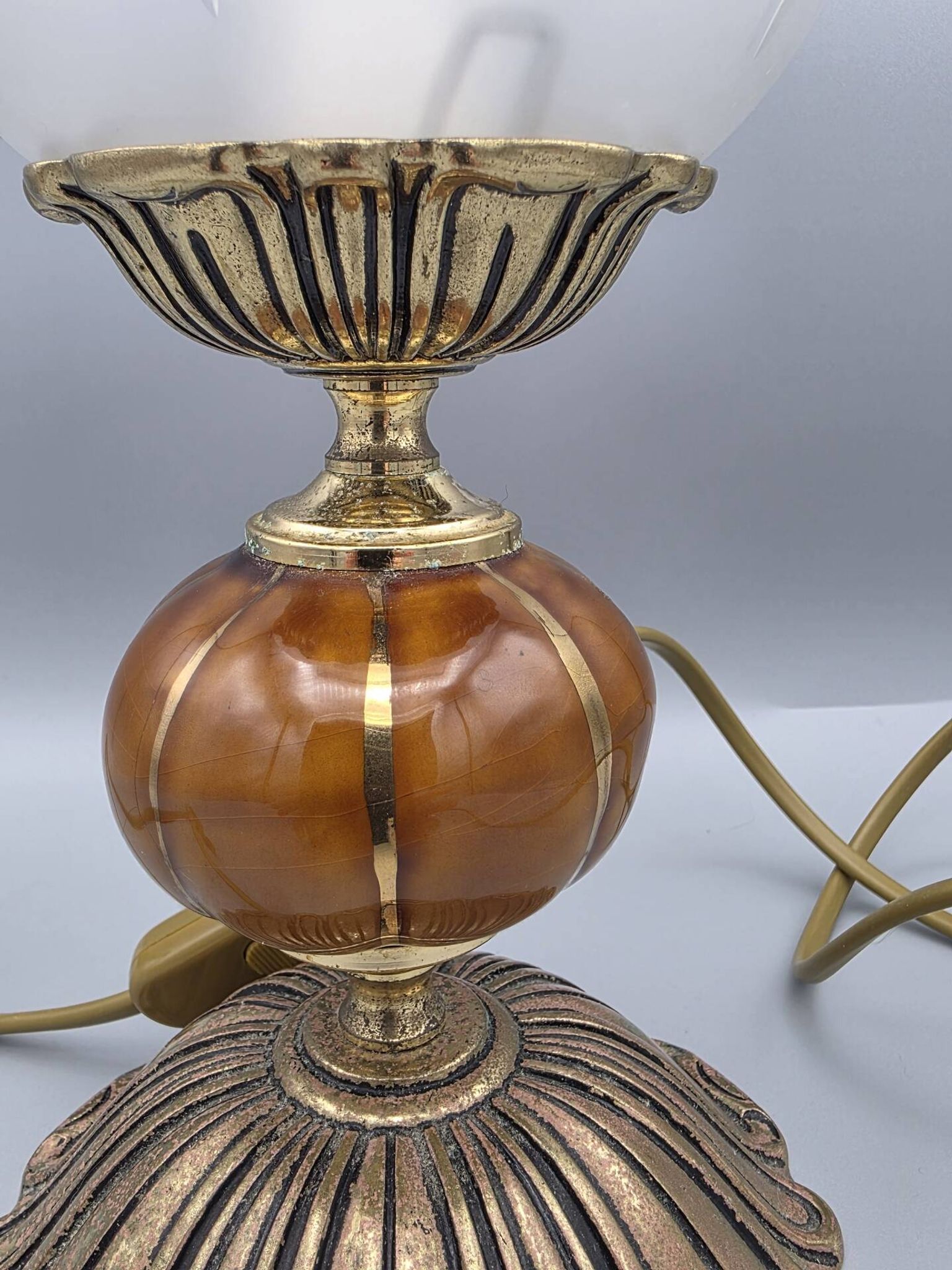 Hollywood Regency bedside lamp in gold metal with a glass globe.