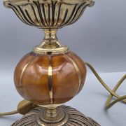 Hollywood Regency bedside lamp in gold metal with a glass globe.