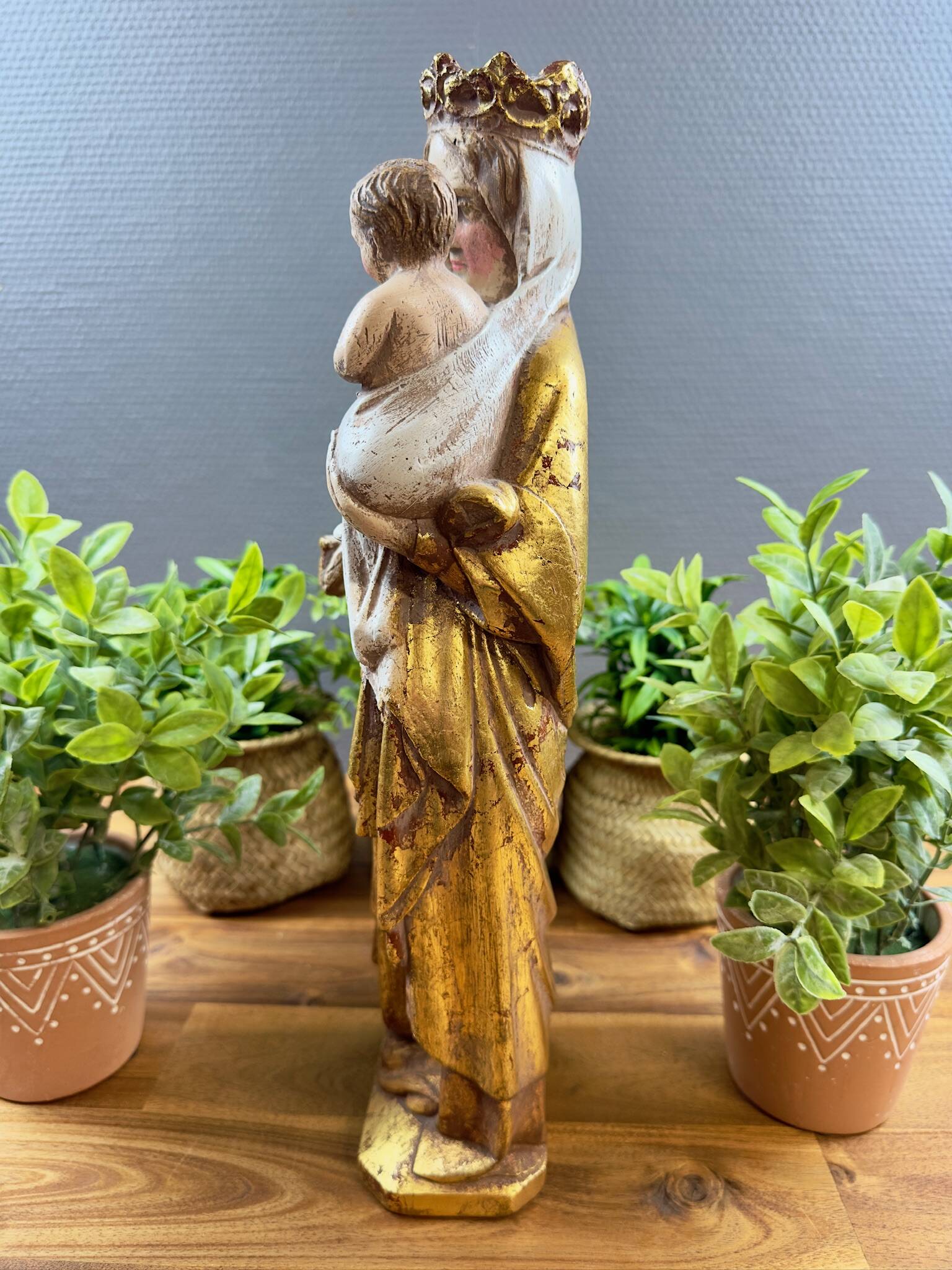 Statue of the Virgin holding the Child Jesus in polychrome terracotta.