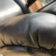 Vintage swivel black leather armchair