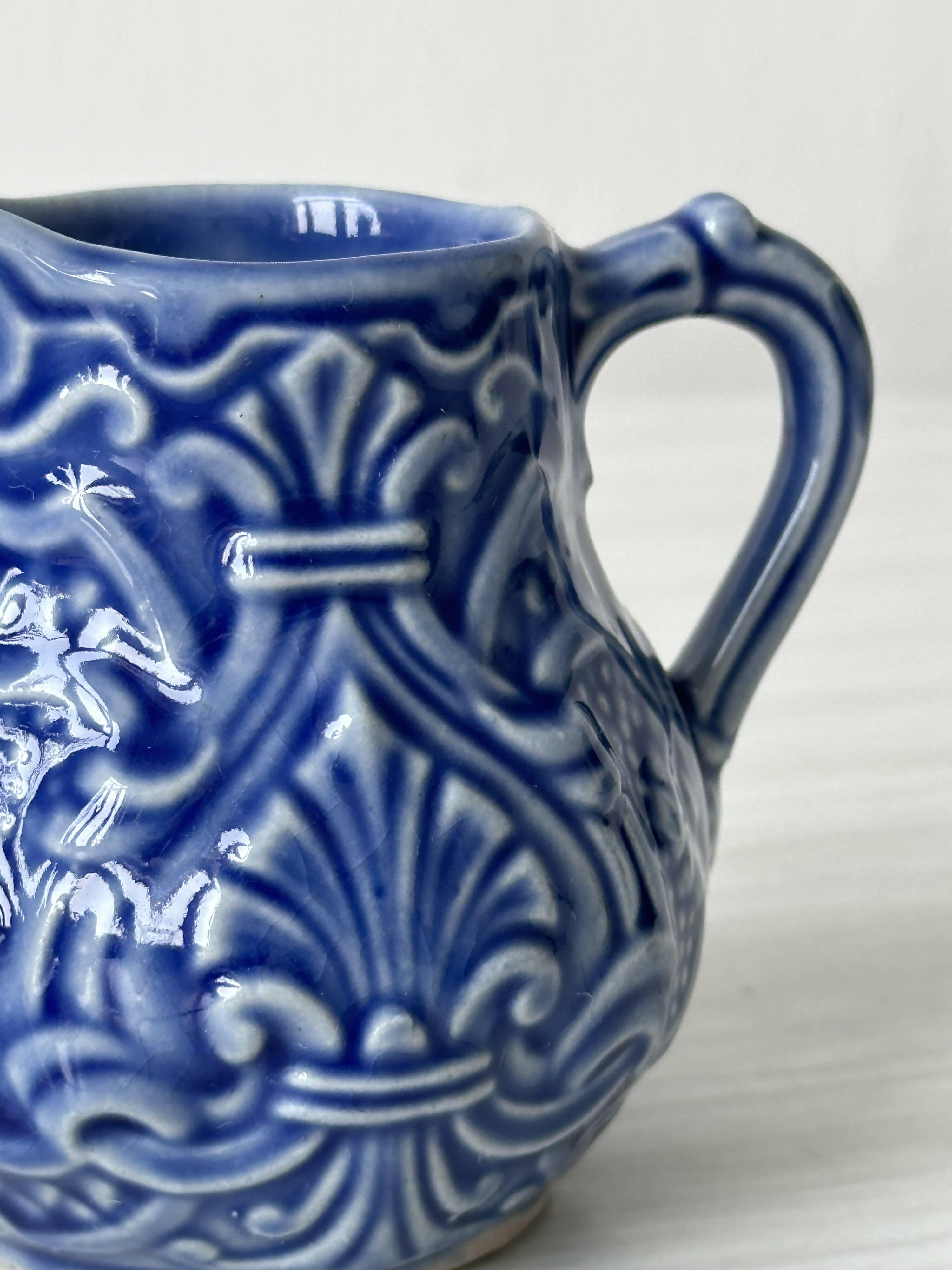 Old cream milk jug in slip