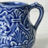 Old cream milk jug in slip
