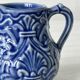 Old cream milk jug in slip
