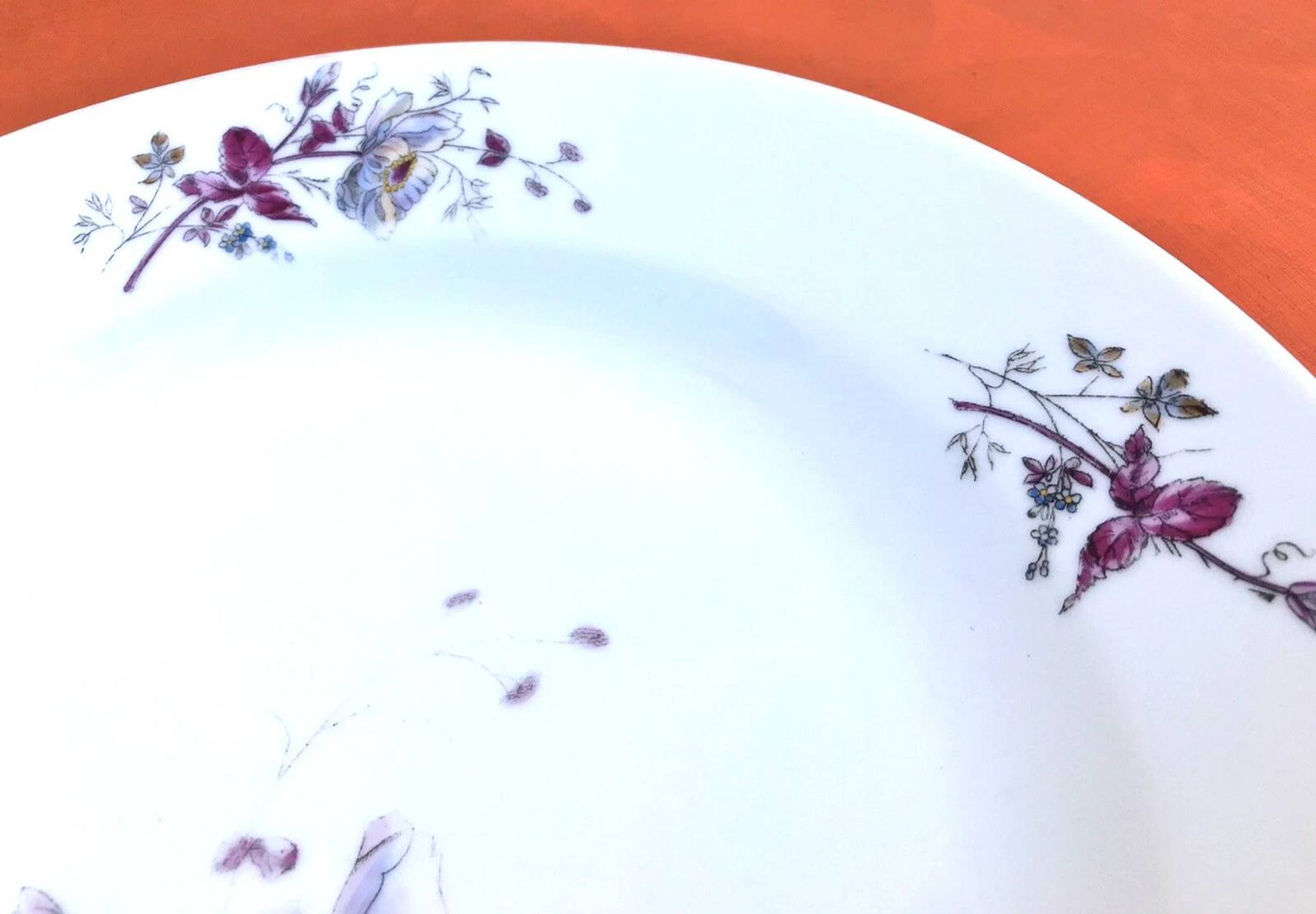 Antique white porcelain shallow dish with floral decoration.
