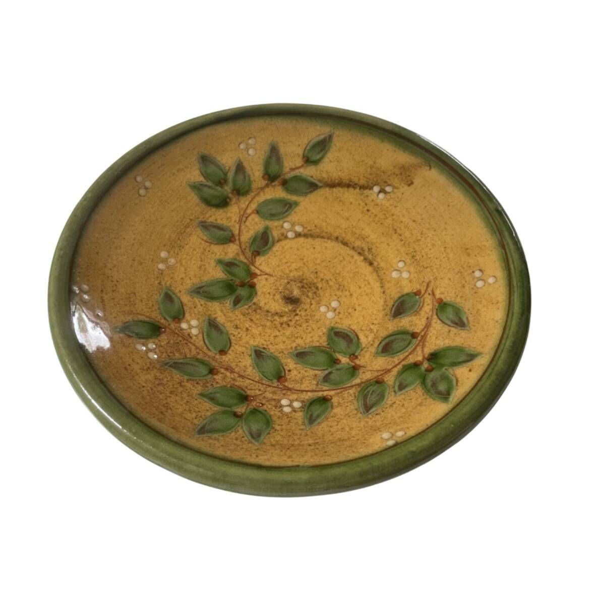 Decorative glazed terracotta plate with olive leaf pattern.