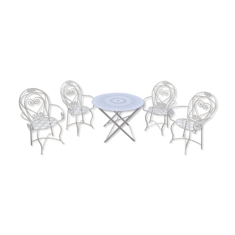 Folding round table and four wrought iron armchairs