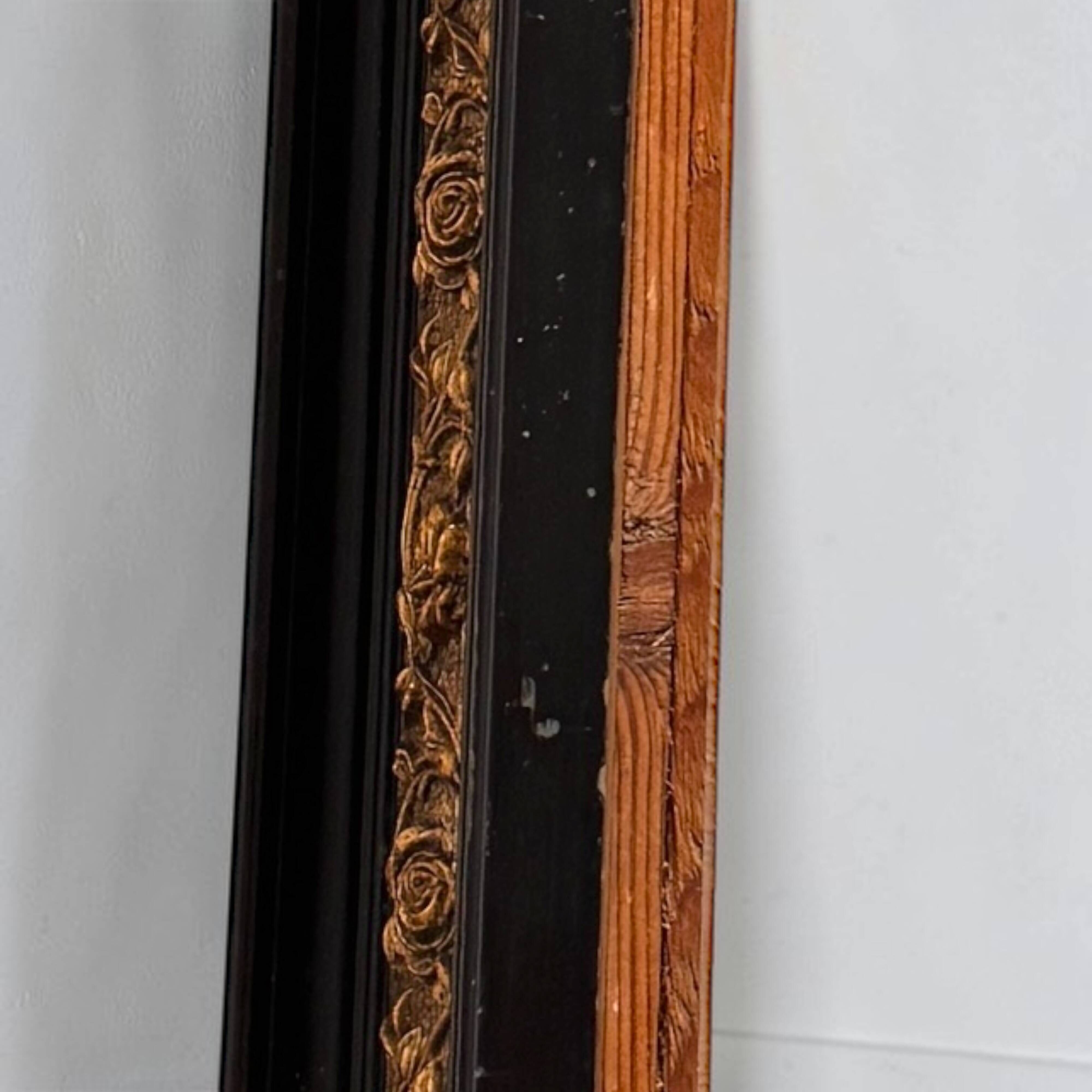 Antique wall mirror in blackened wood and gilded stucco, 19th-century Dutch style.