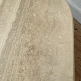 Travertine coffee table in eye shape.