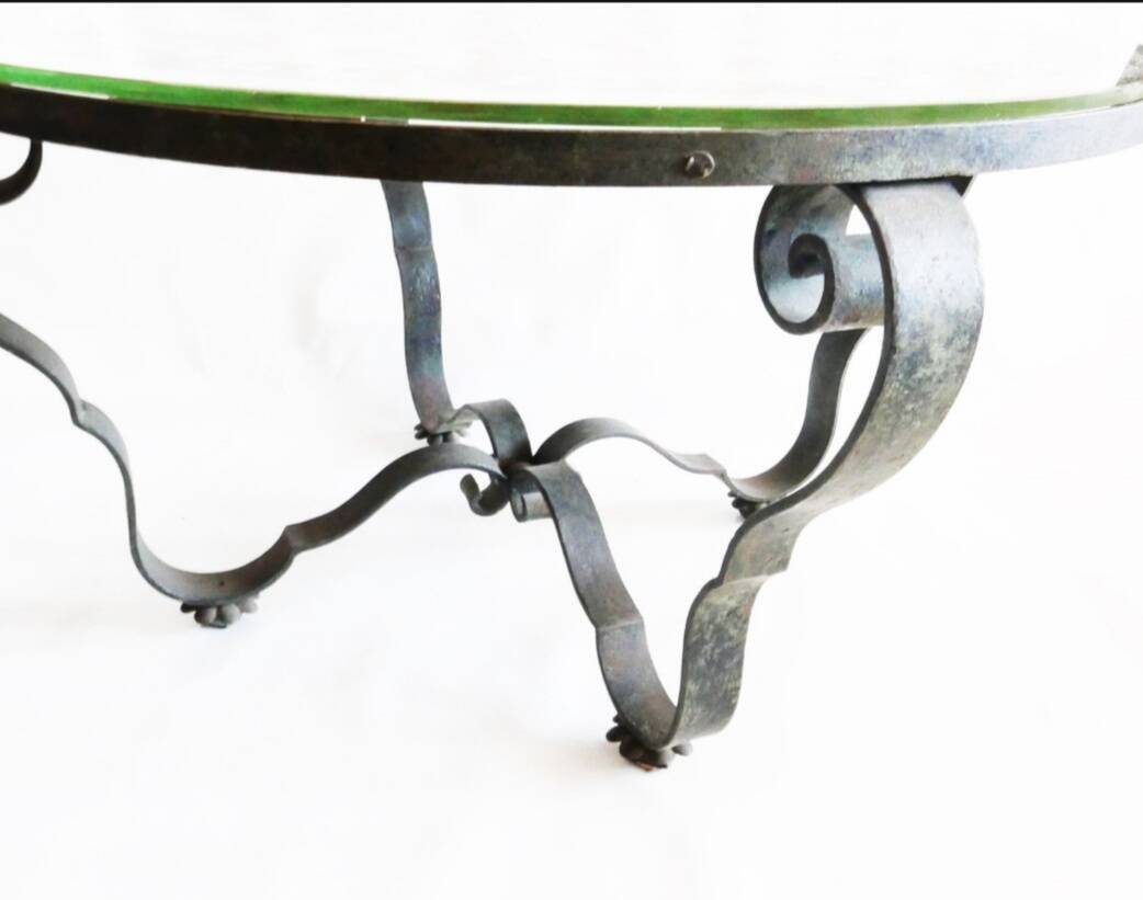 Round table from the 1940s, wrought iron and eglomisé glass.