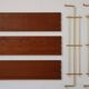 String shelf in teak and gold metal