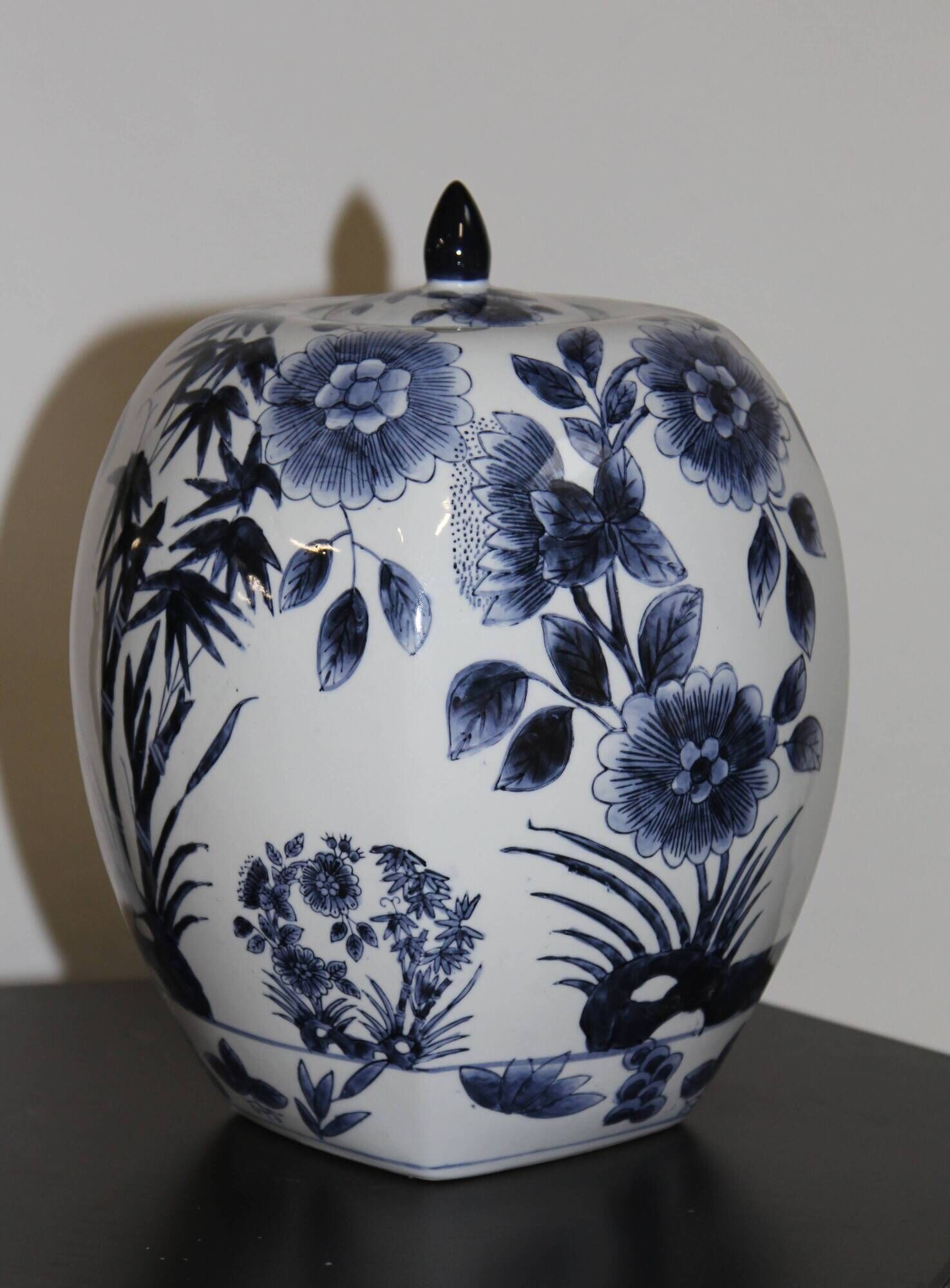 A pair of Chinese blue and white ovoid vases and flush-fitting circular covers