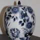 A pair of Chinese blue and white ovoid vases and flush-fitting circular covers