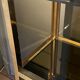 Hollywood Regency style bookcase shelf, gilded brass and black lacquered wood, 1970