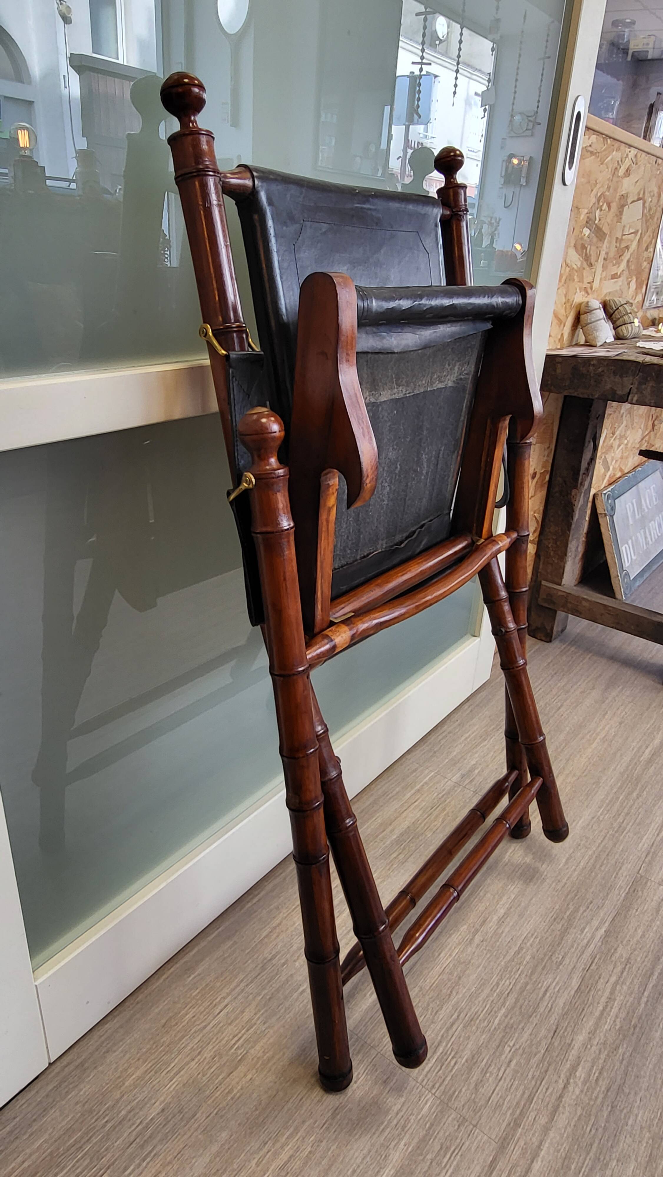 Colonial style folding leather and teak armchair