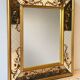 Large Venetian-style mirror with golden floral decoration.