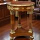 Circular gueridon empire of the 19th century in marquetry ornamented with gilt bronze
