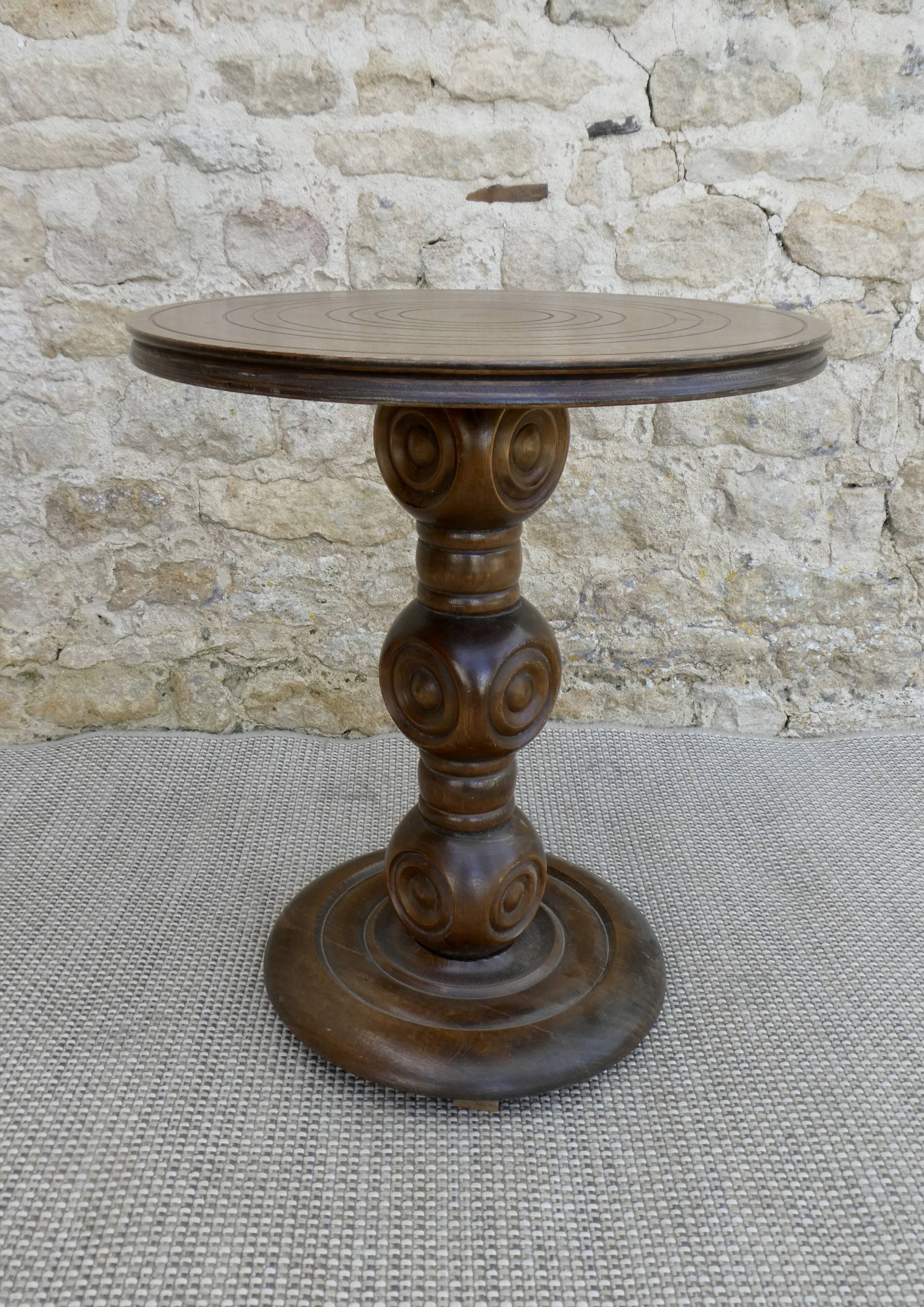 Pedestal table on carved wooden base