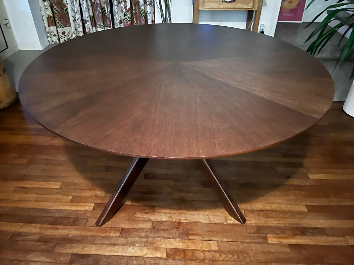 Round table made of solid wood with a walnut finish top.