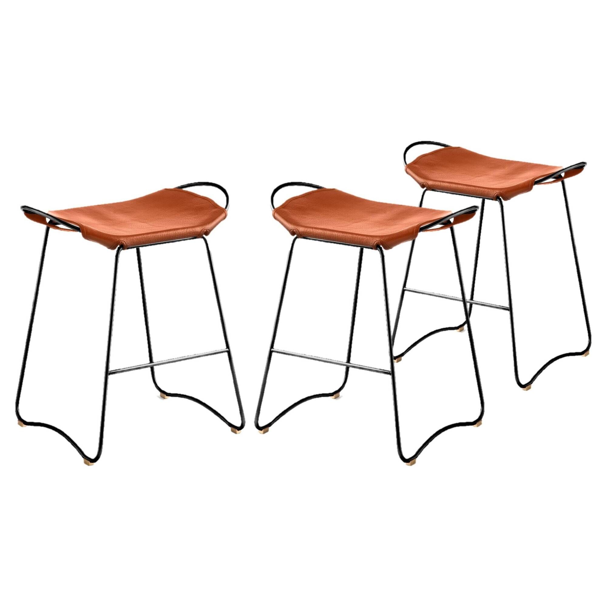 Set of 3 contemporary bar stools in black steel and natural leather.