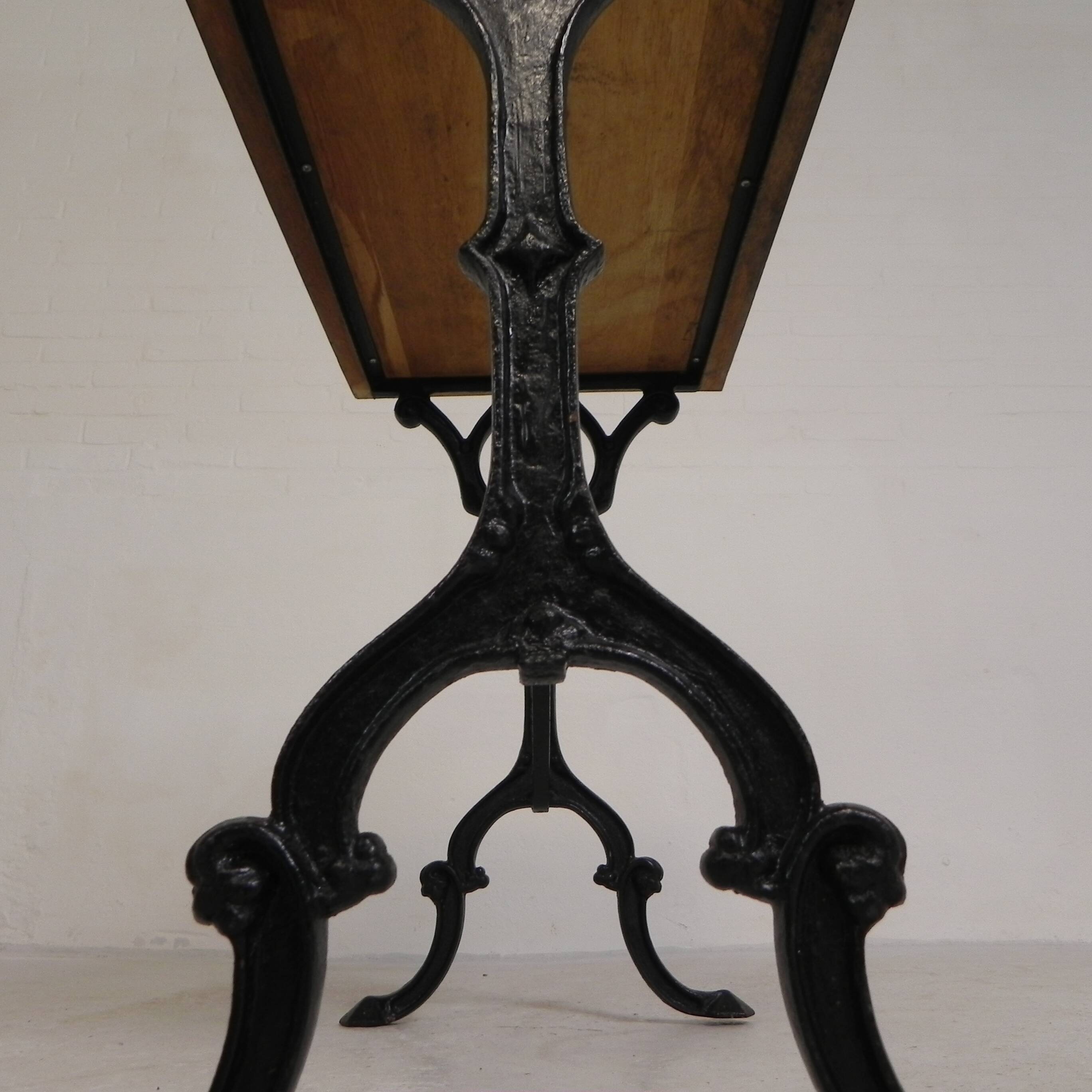 Bistro table with an oak top on a cast iron base, 1930s.