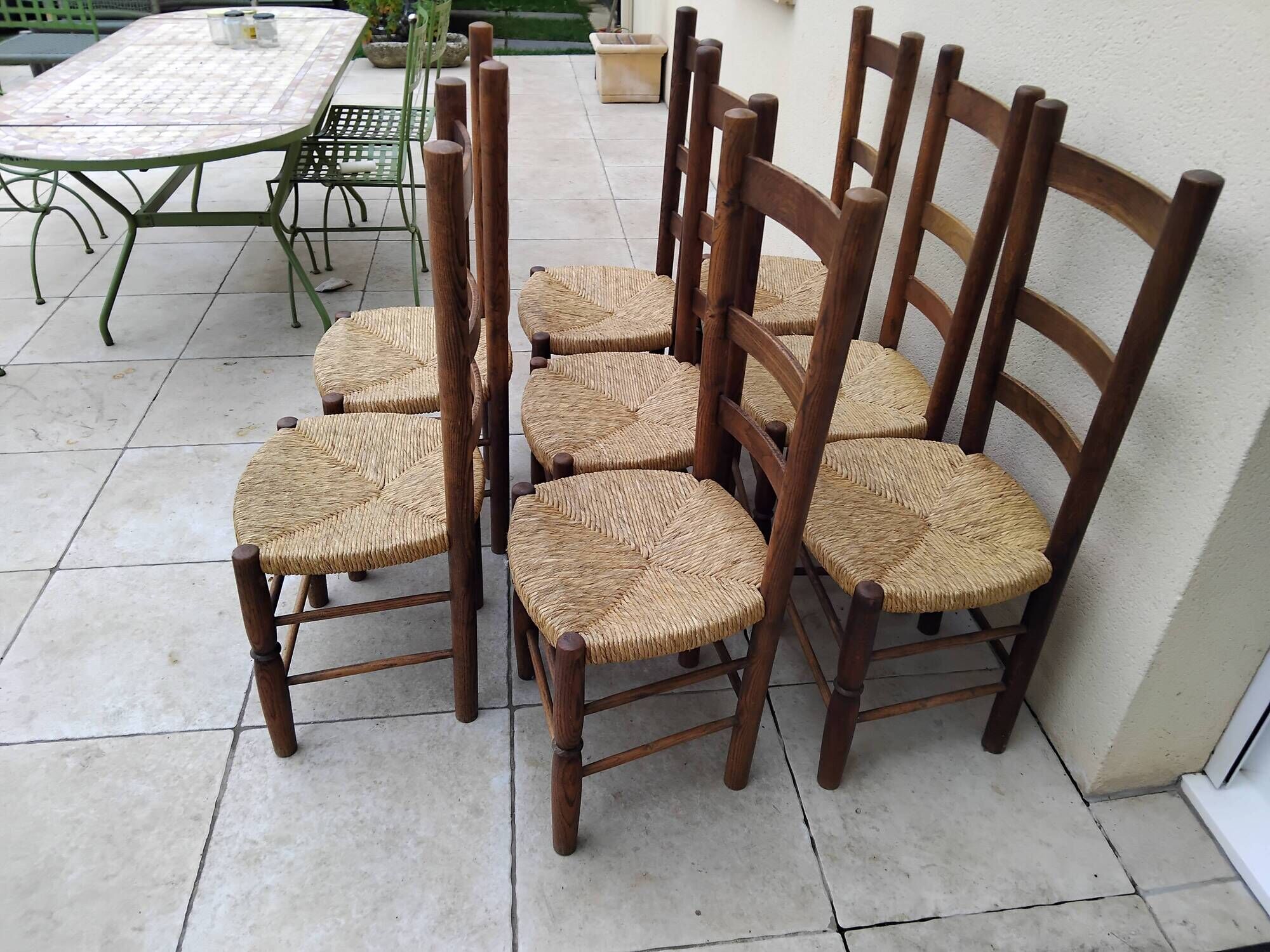 8 vintage straw chairs in the style of Charlotte Perriand.