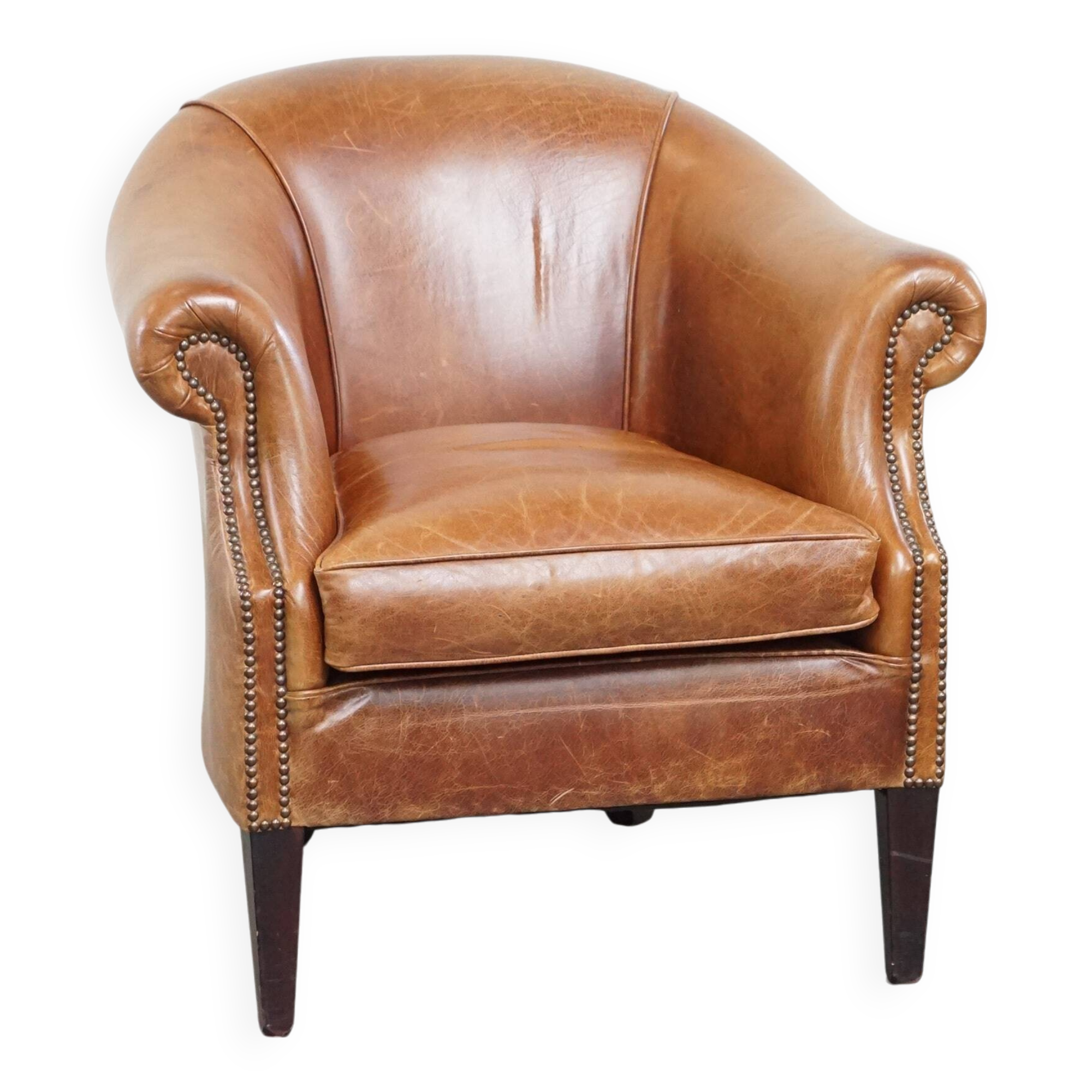 Very comfortable, elegant leather club armchair with a removable seat cushion and timeless design