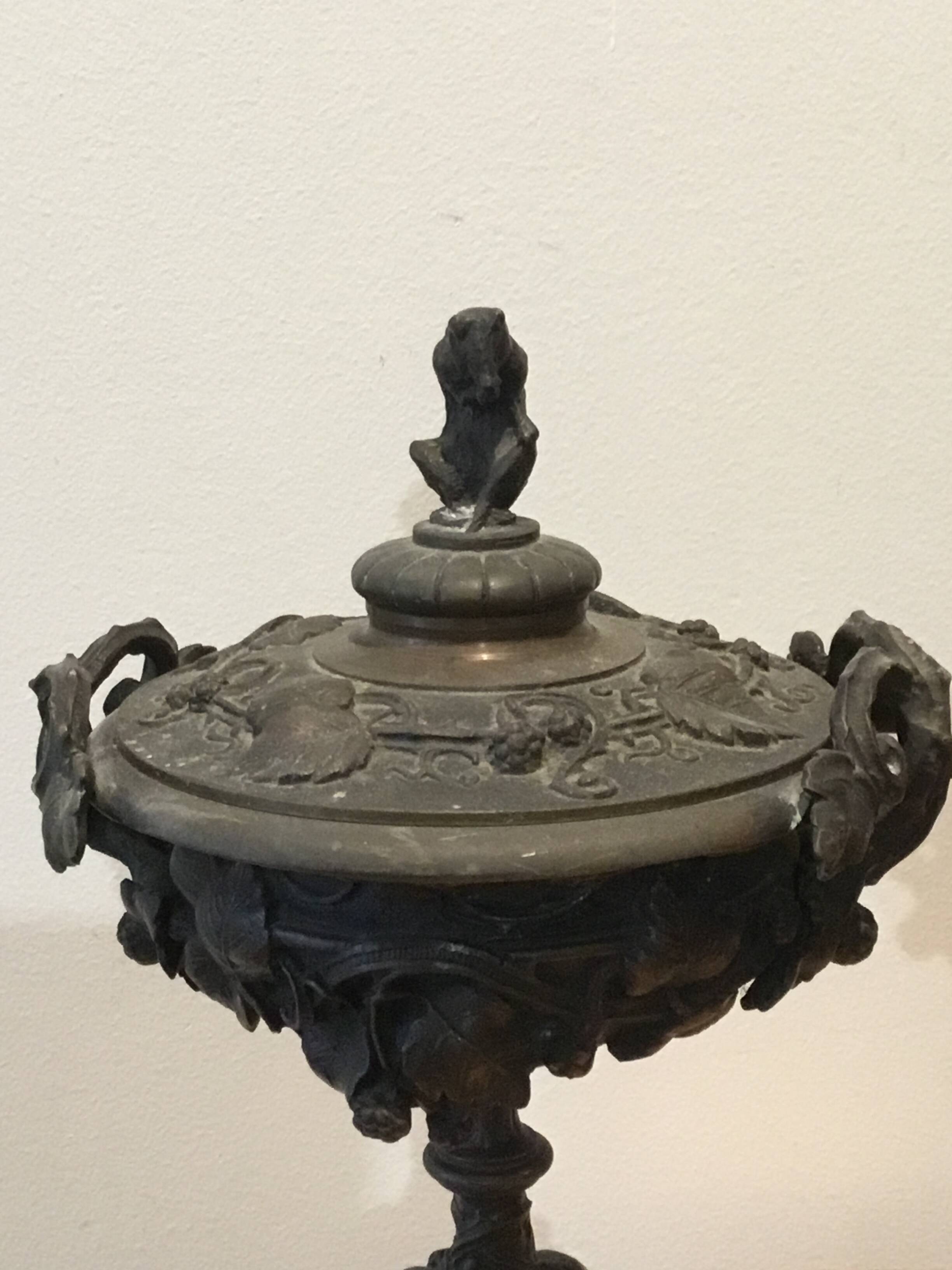 Bronze fireplace garnitures with marble base depicting leaves.