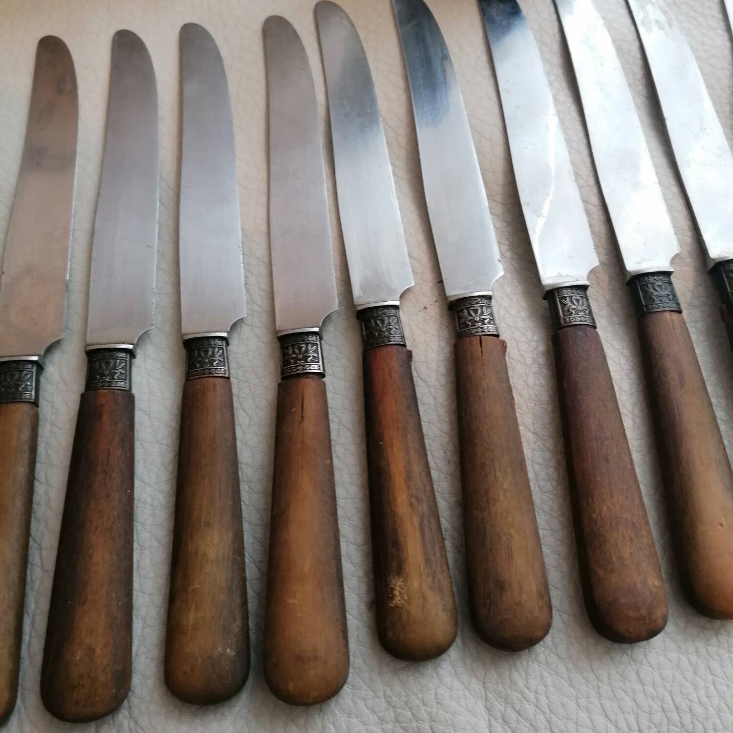 Old table knives and dessert knives, wooden handles, stainless steel blades