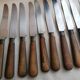 Old table knives and dessert knives, wooden handles, stainless steel blades
