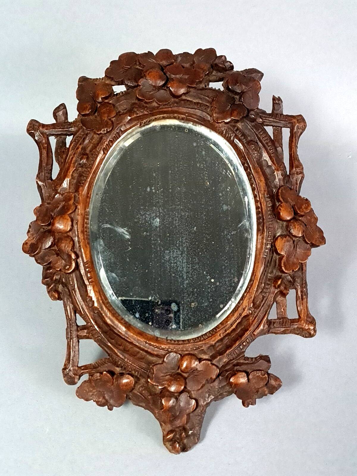 Antique small beveled mirror with carved wooden frame and waxed patina C714