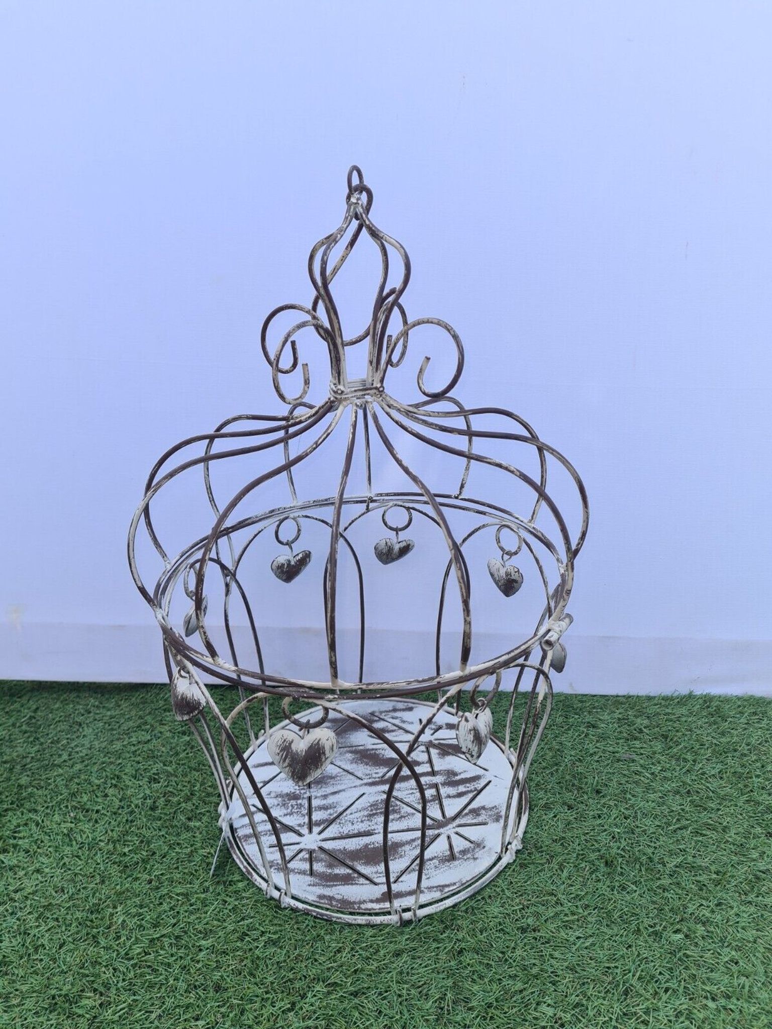 Decorative bird cage with iron hearts