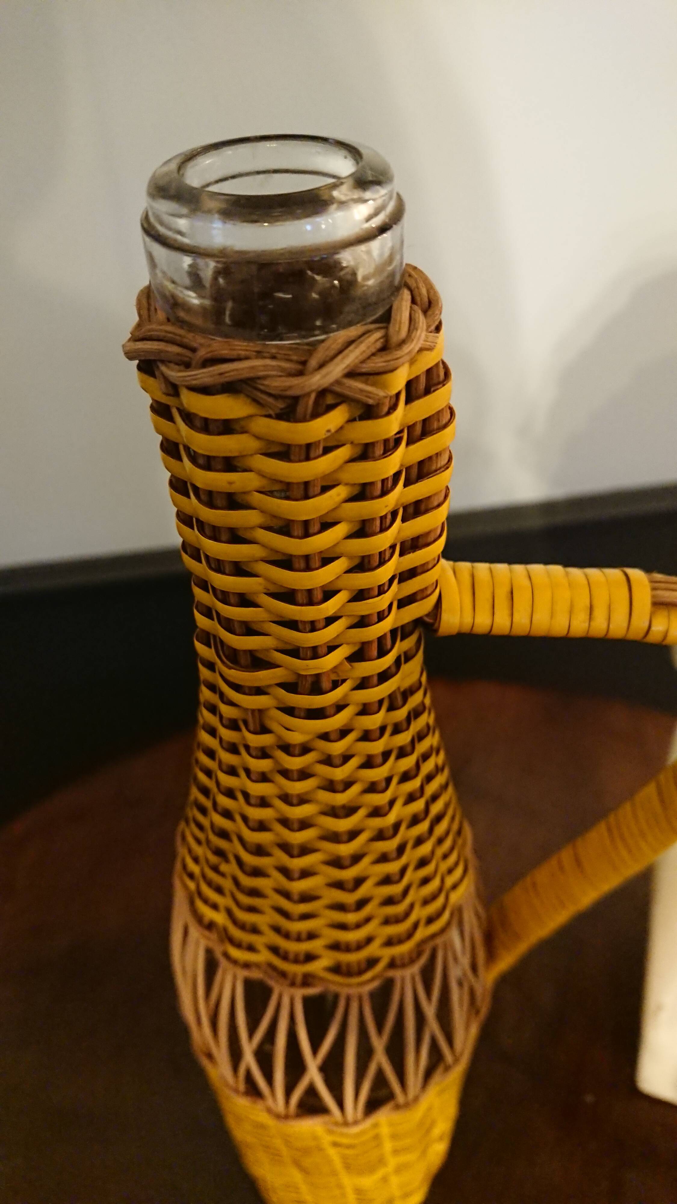 Natural and yellow braided glass and rattan bottle