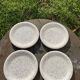 4 black speckled dessert plates on a vintage white background