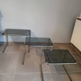 Set of 3 nesting tables with chrome metal legs and smoked glass from the 70s