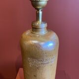 "Stoneware Bottle Lamp" with a multicoloured blue lampshade handwoven in India.