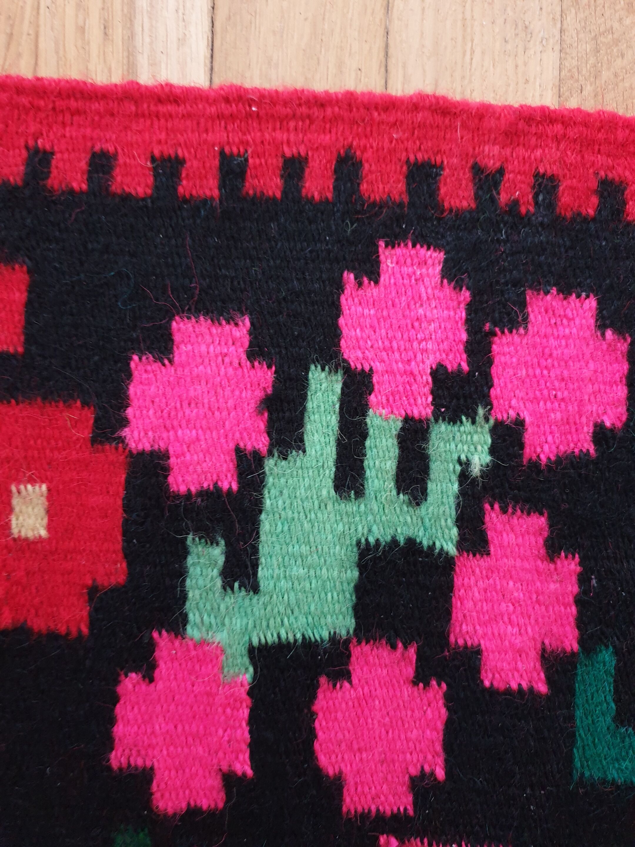 Colorful kilim on black background with floral design