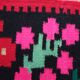 Colorful kilim on black background with floral design