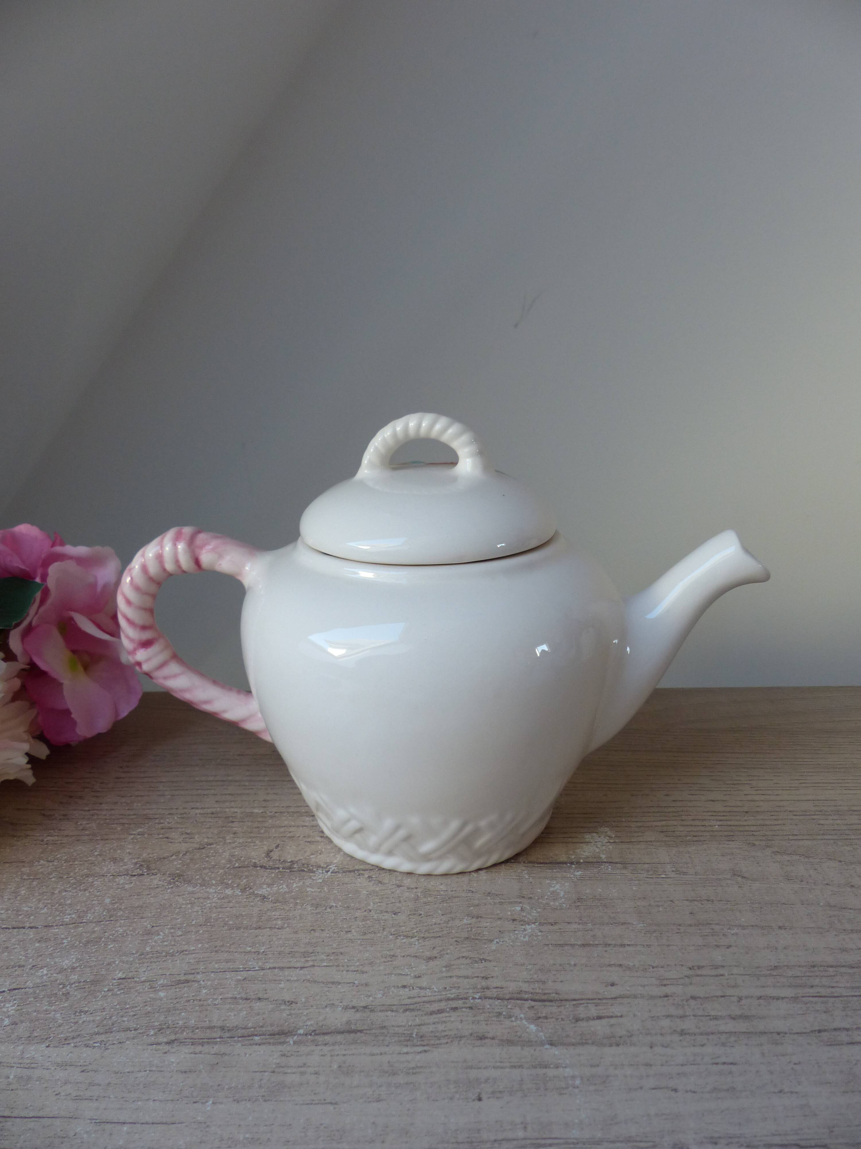 Old ceramic teapot in the shape of a basket of fruits from the garden