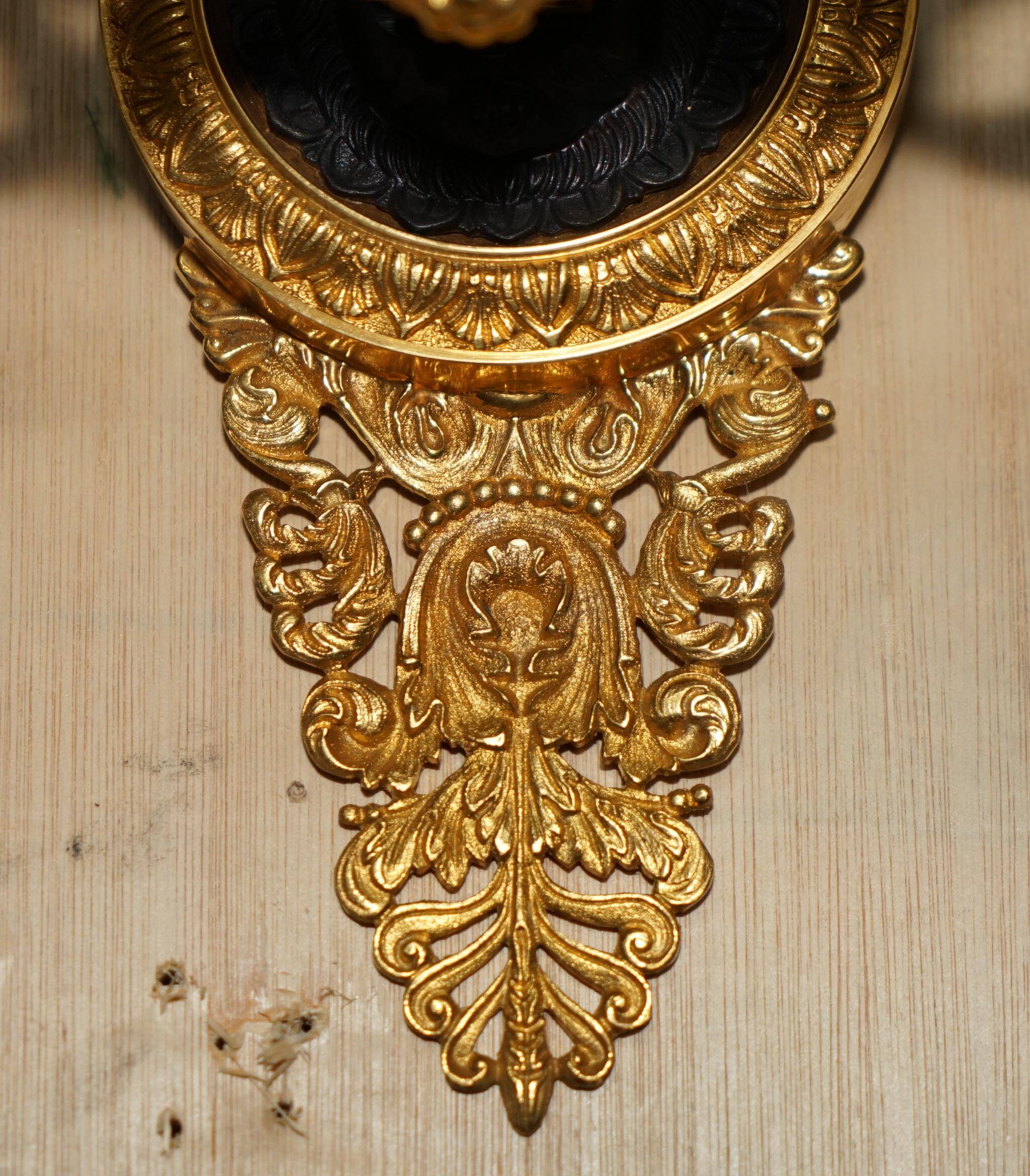 Pair of L'Originale wall sconces plated with 24-carat gold featuring four bronze candles.